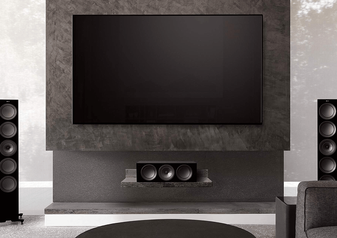 Living room with large TV, two floorstanding speakers, a centre channel and a subwoofer.