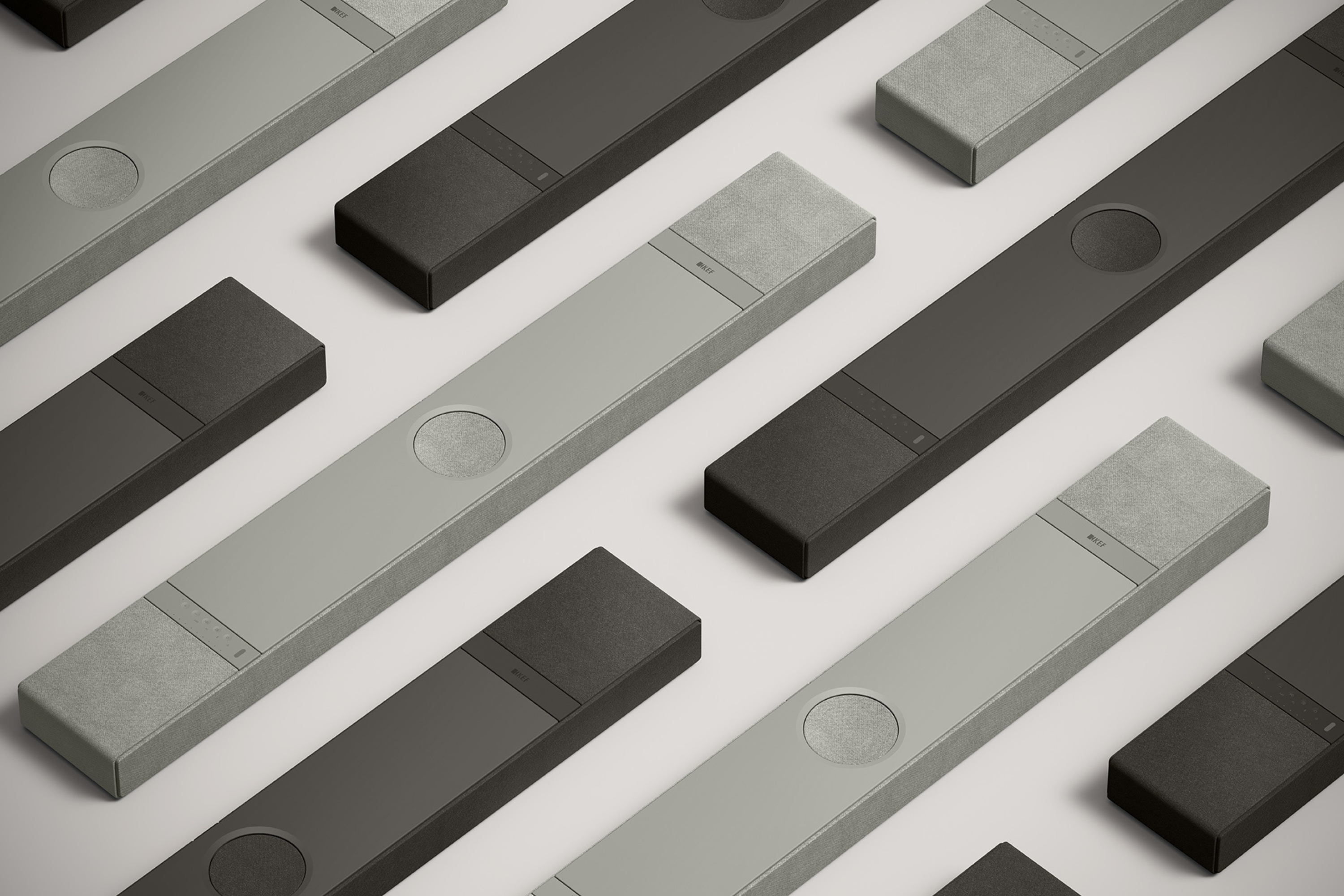 Modern soundbars in minimalist design, displayed in alternating dark and light grey tones on a neutral background.