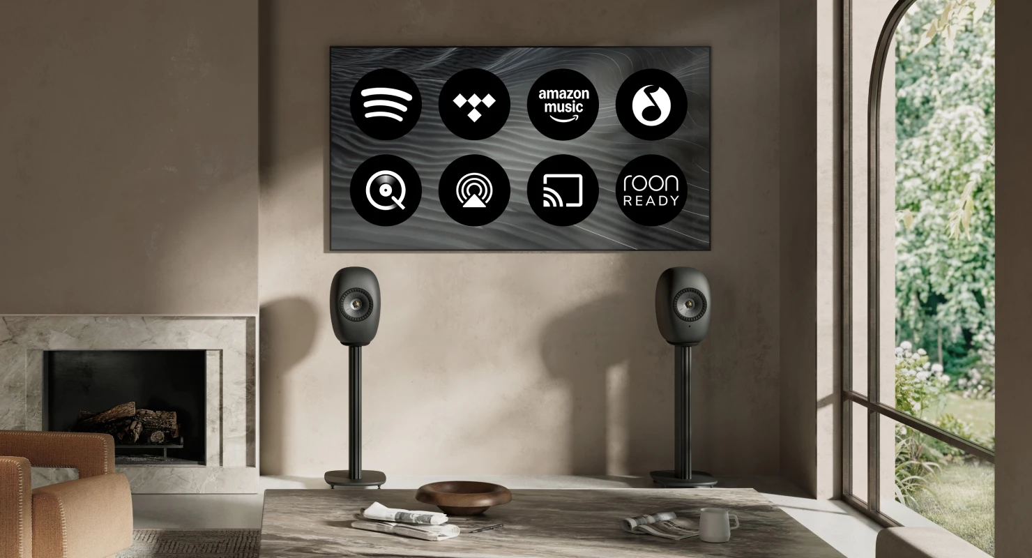 Blue Muo Bluetooth speaker hanging from carrying strap in bathroom is being controlled via phone.