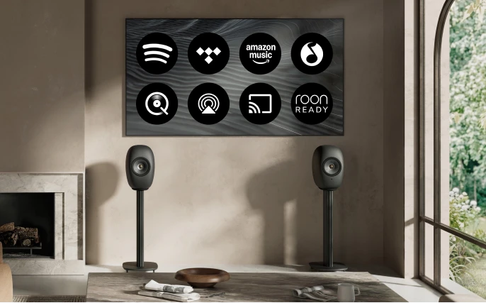 Blue Muo Bluetooth speaker hanging from carrying strap in bathroom is being controlled via phone.
