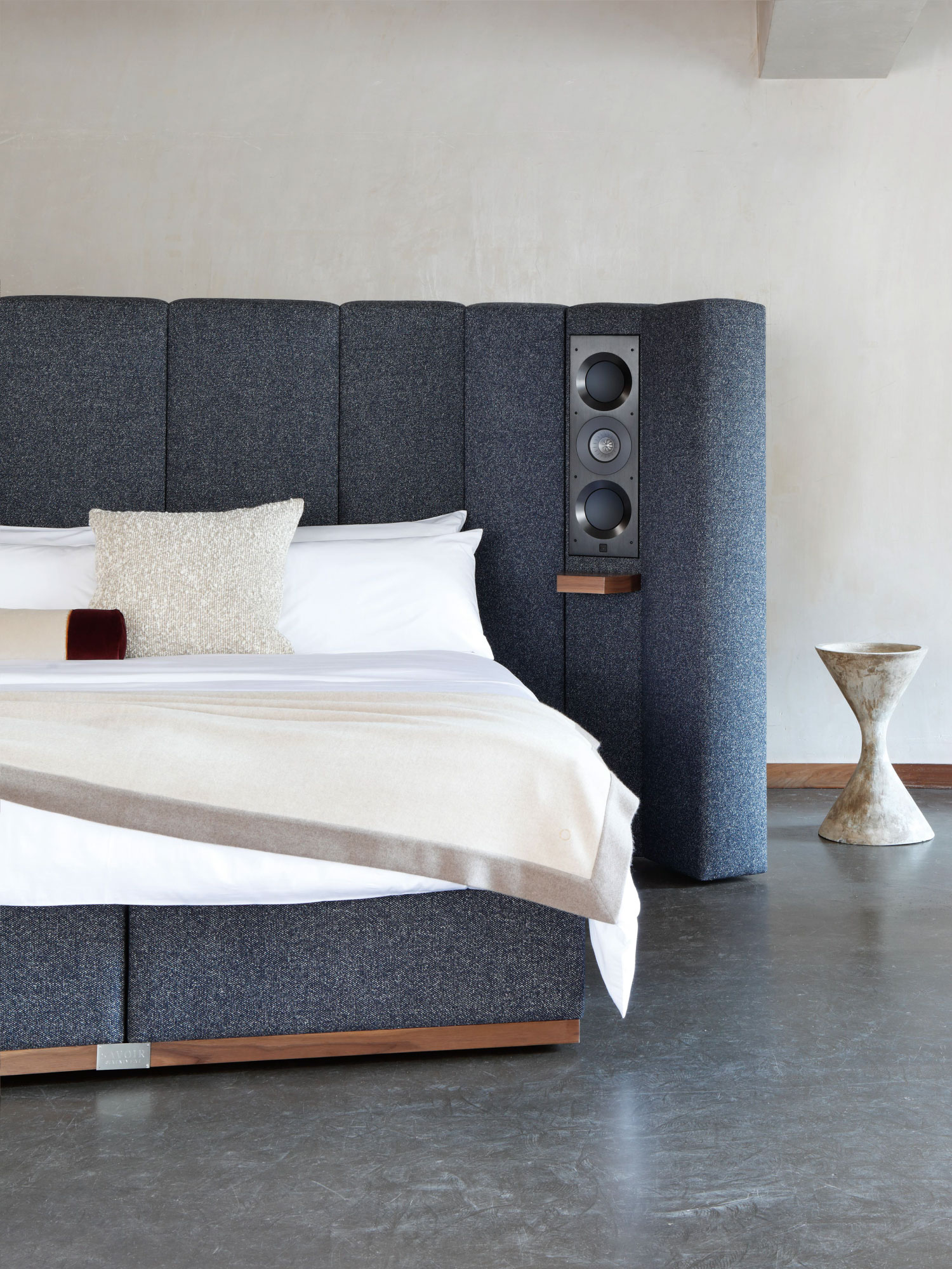 Close-up of Savoir bed focusing on the left side featuring one of KEF's speakers