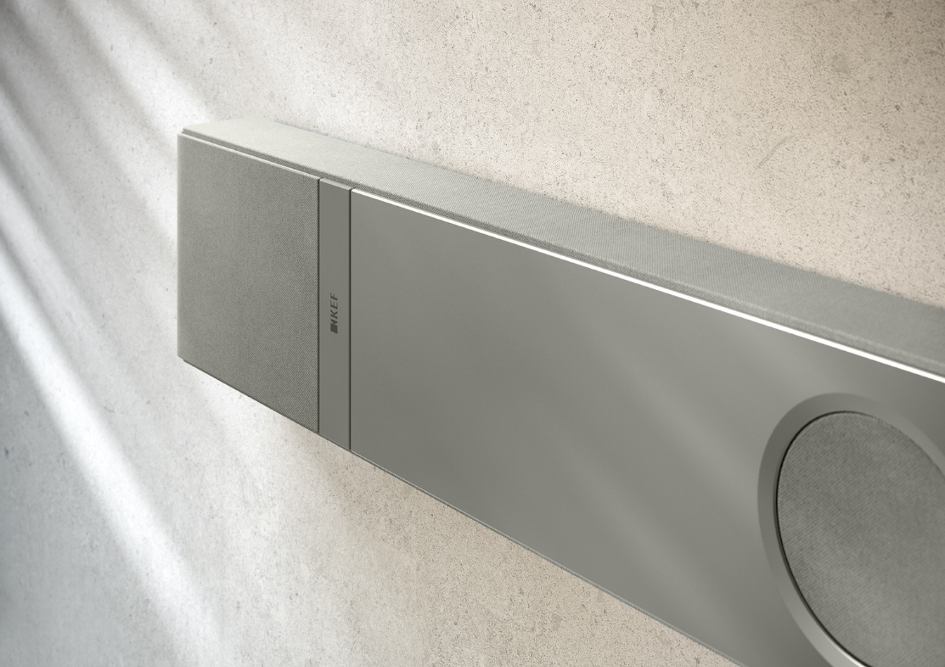 Gros plan sur une barre de son élégante et moderne en argent, fixée sur un mur clair.