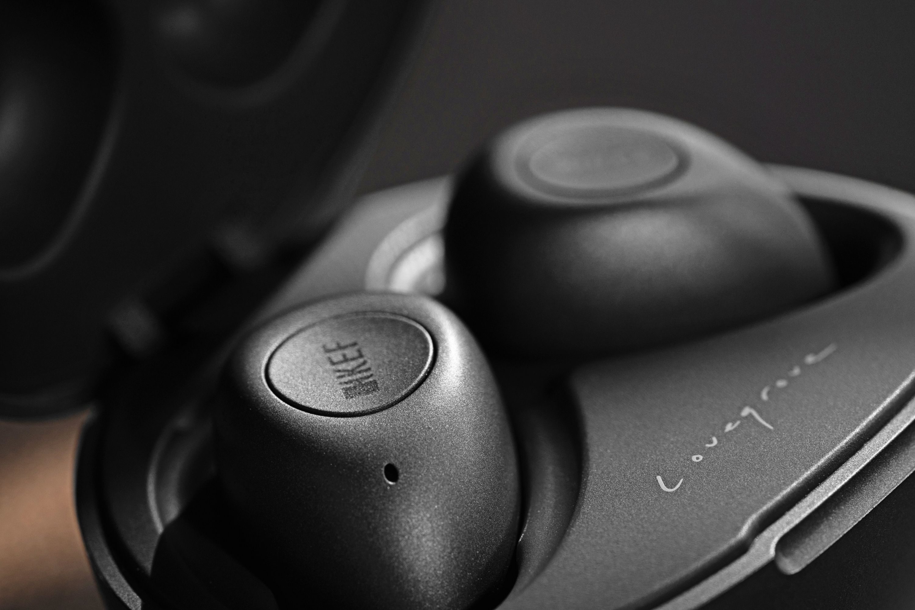 Close up image of pair of KEF Mu3 earphones charcoal grey 