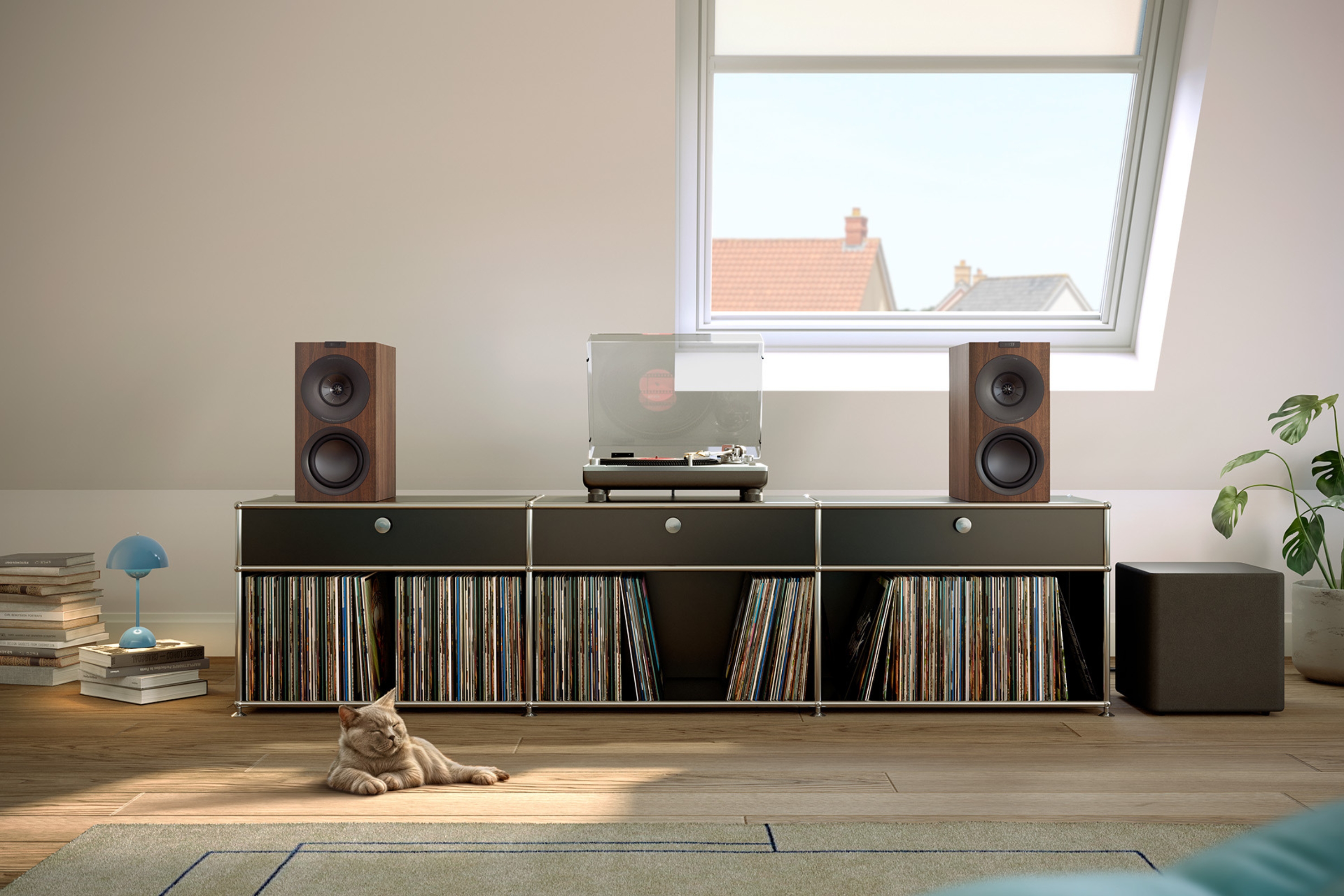Stereo hi‑fi system with wooden bookshelf speakers, vinyl record collection and turntable in a cosy loft living space.