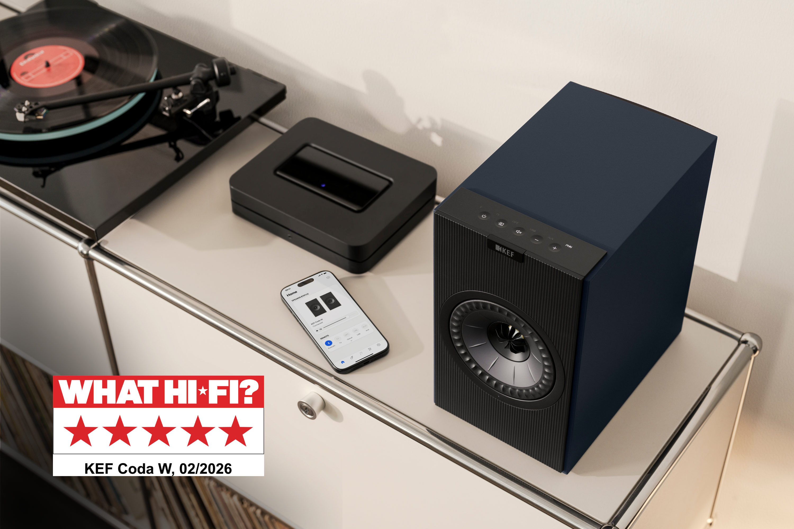 KEF Coda W Speakers on a cabinet next to a turntable
