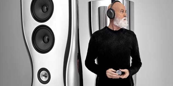 A pair of luxury MUON HiFi speakers next to designer Ross Lovegrove.