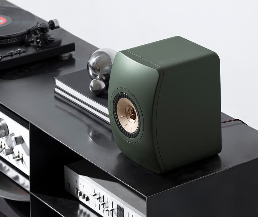 Modern KEF speakers on shelf.